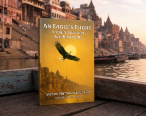 An Eagle’s Flight trade paperback standing in a boat on the Ganges with the Varanasi ghats beyond