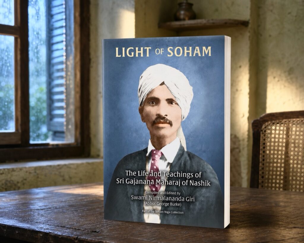 The Light of Soham trade paperback on a wooden table beside a quiet rain-lit window